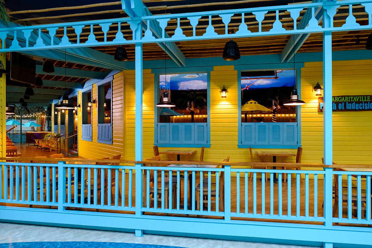 Porch of indecision Interior in blue with chairs and tables